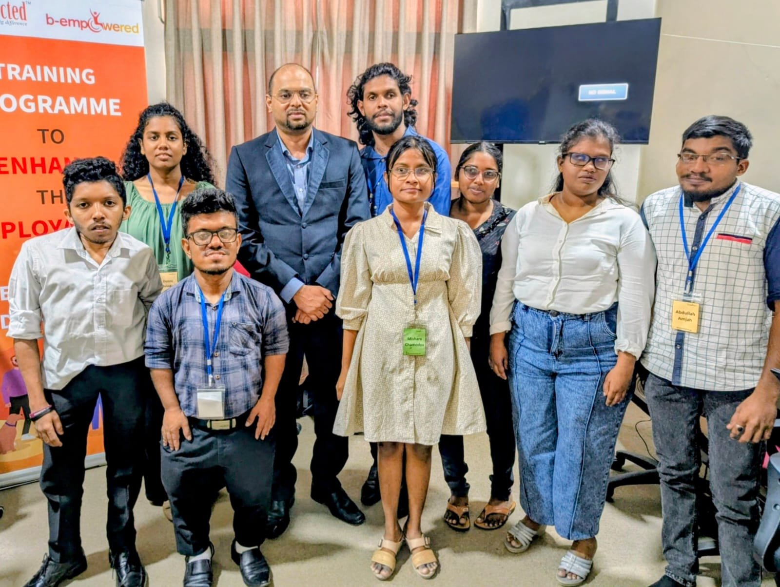 Participants and facilitators of the BEmpowered employability training programme standing together for a group photograph beside the programme banner.